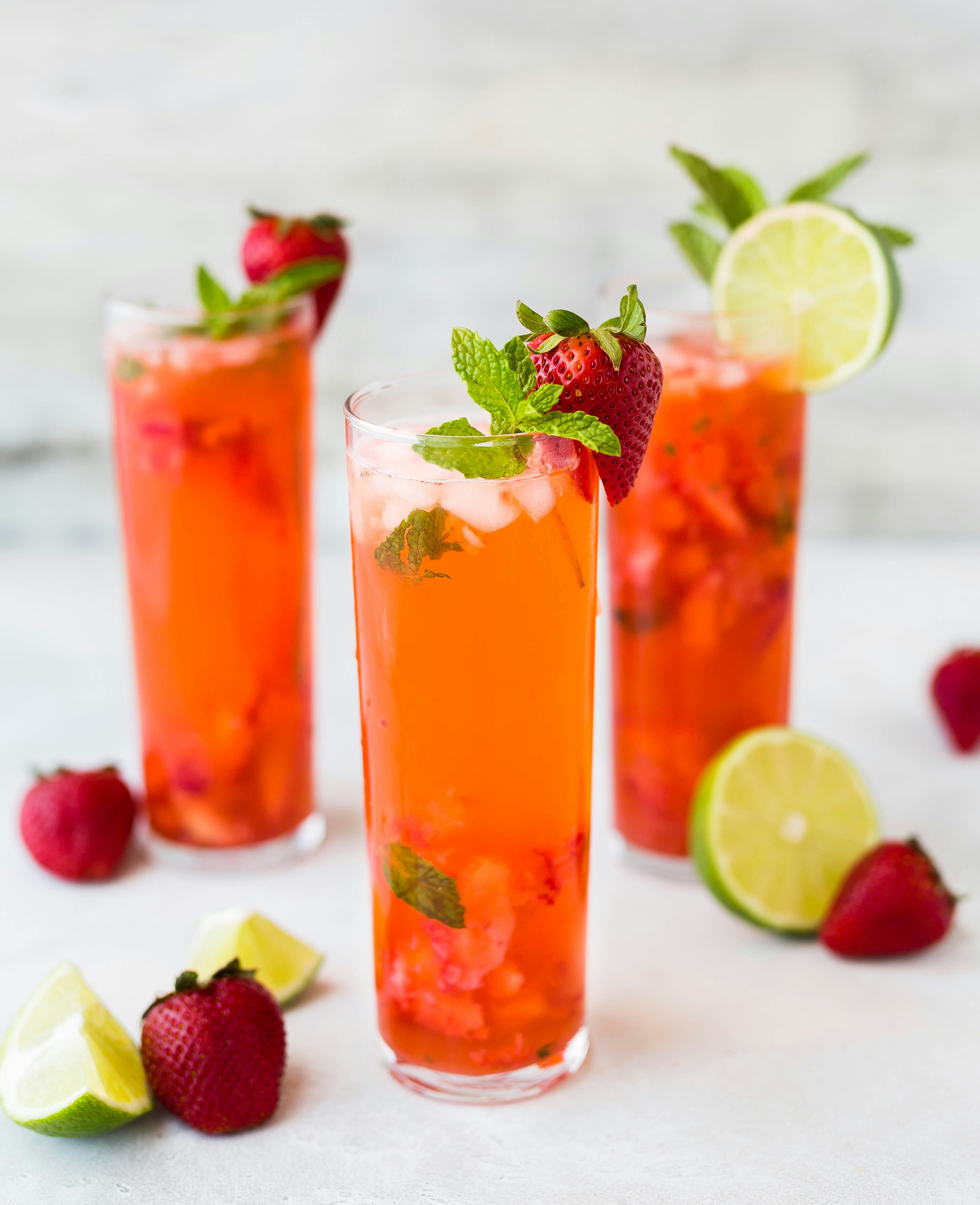 mint strawberry italian lemonnade with fresh cut strawberrys and mint leaves